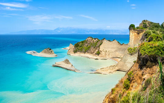 Cape Drastis cliffs near Sidari and Peroulades on Corfu island in Greece. Famous rock formations with small beach and rugged coastline. Popular Greek destination for summer vacation.